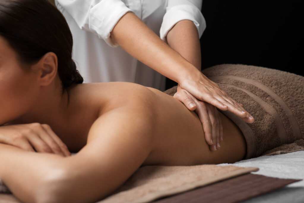 woman lying on her stomach and having back massage