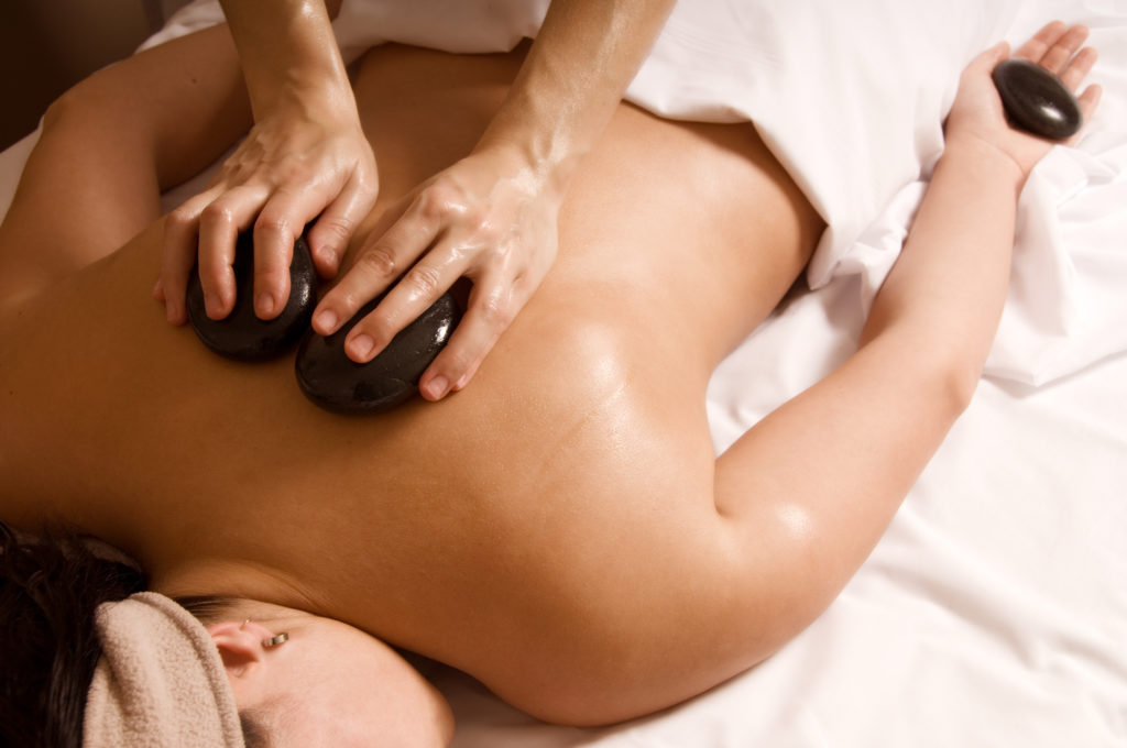 women laying on stomach getting hot stone massage